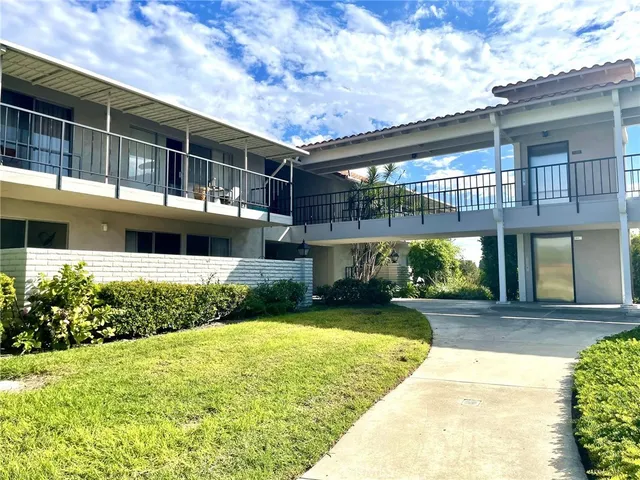 a view of a house with a backyard porch and sitting area