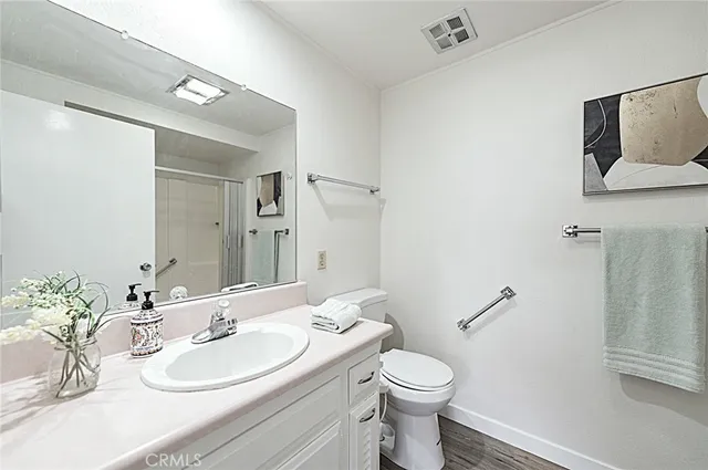 a bathroom with a toilet a sink and a mirror