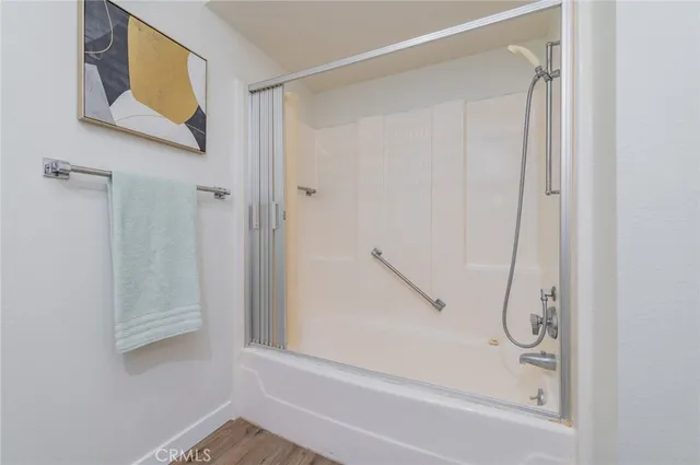a bathroom with a glass shower door