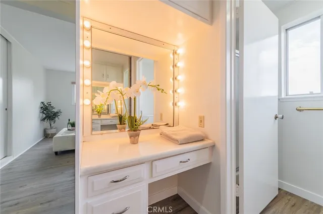 a en suite bathroom with a granite countertop sink and a mirror