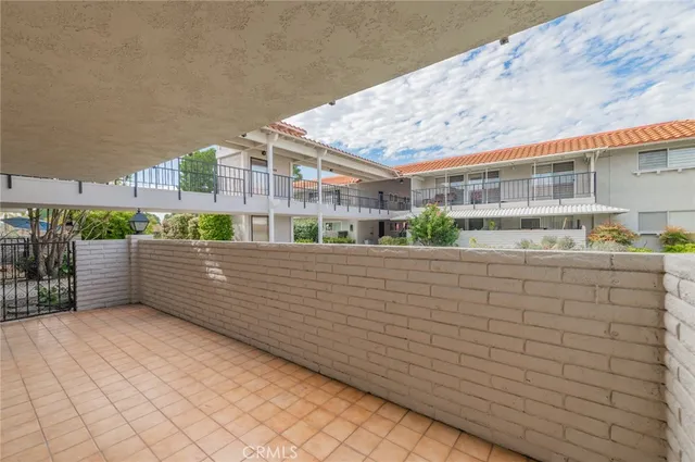 a view of balcony with wooden floor and fence