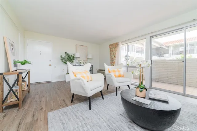 a living room with furniture and a potted plant