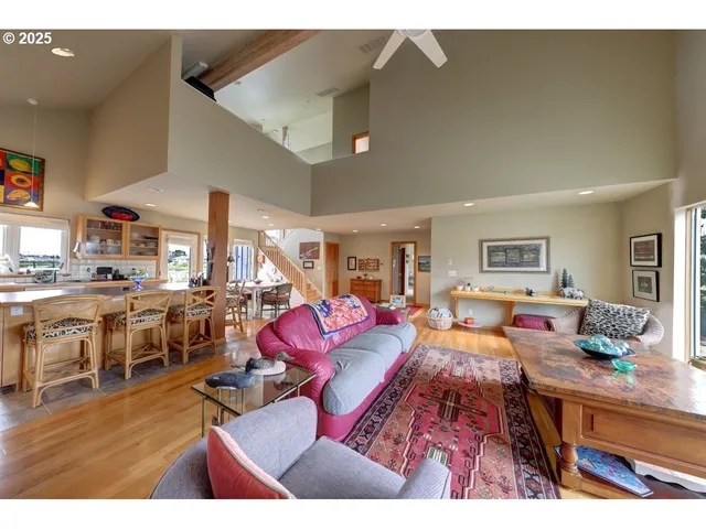 a living room with lots of furniture and view kitchen
