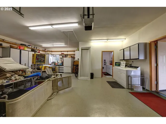 a kitchen with stainless steel appliances kitchen island granite countertop a stove and a refrigerator