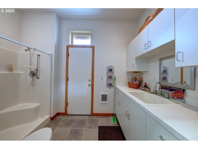 a kitchen with a sink a refrigerator and cabinets