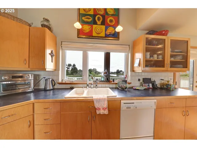 a kitchen with stainless steel appliances granite countertop a sink and cabinets