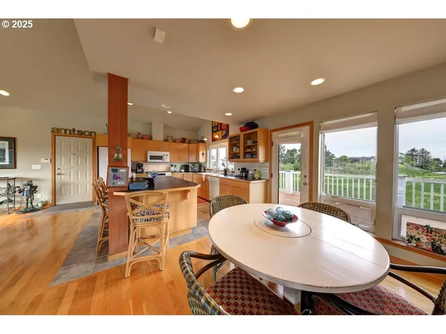 a kitchen with dining table and a refrigerator