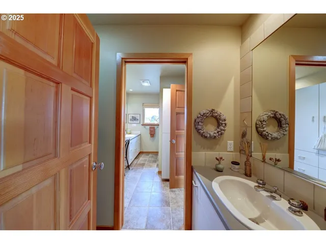 a bathroom with a granite countertop sink a mirror and a vanity