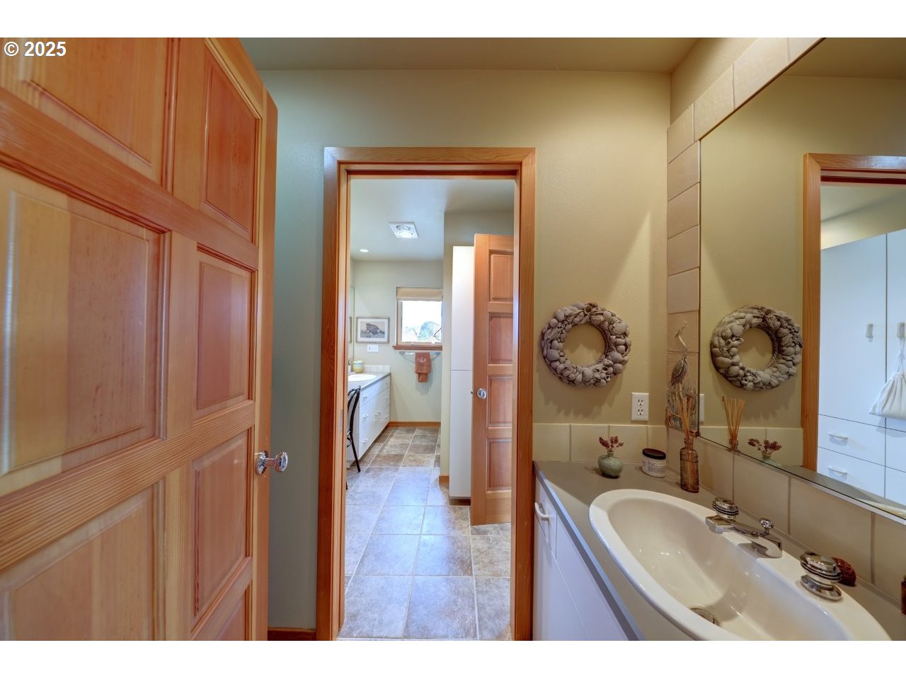 500 Farrell Court Seaside, OR 97138 - Photo 19 of 39 a bathroom with a granite countertop sink a mirror and a vanity