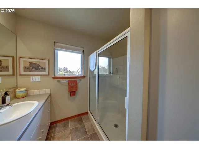 a bathroom with a sink mirror and a shower