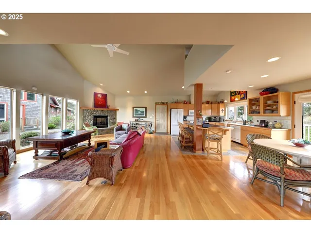 a living room with lots of furniture and kitchen view