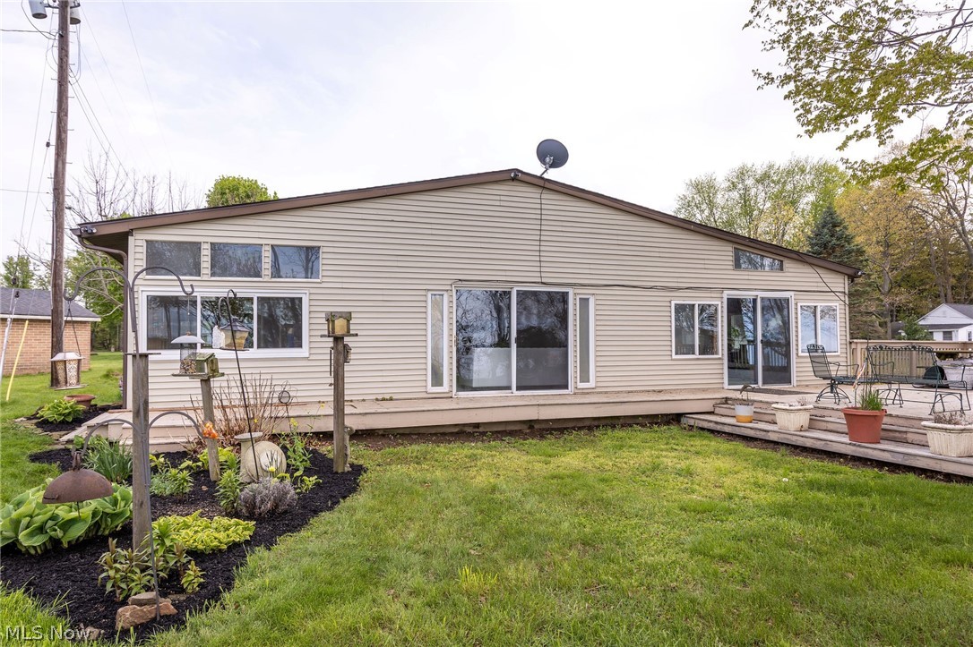 5467 Chapel Road Madison, OH 44057 - Photo 5 of 50 Rear exterior featuring beige horizontal siding and a brown shingle roof