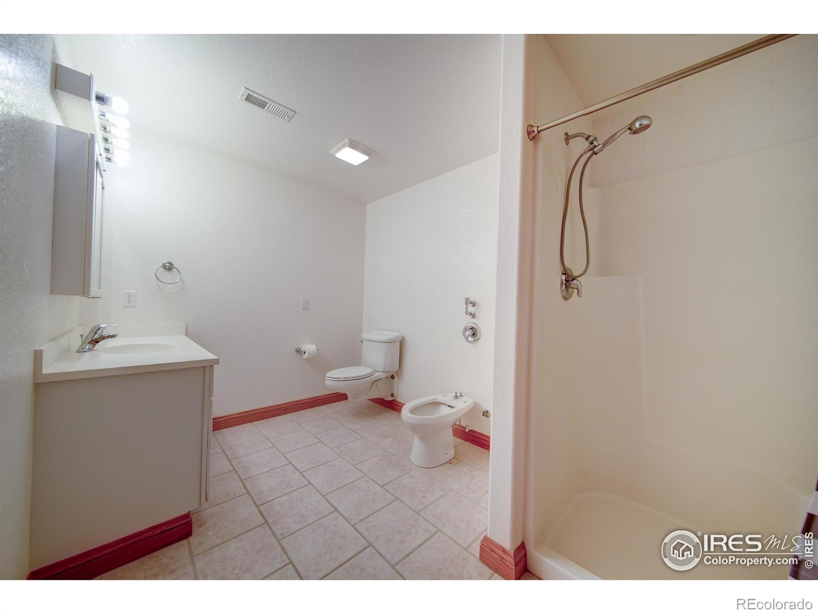 17606 County Rd Q.8 Fort Morgan, CO 80701 - Photo 34 of 37 a bathroom with a sink mirror vanity and toilet
