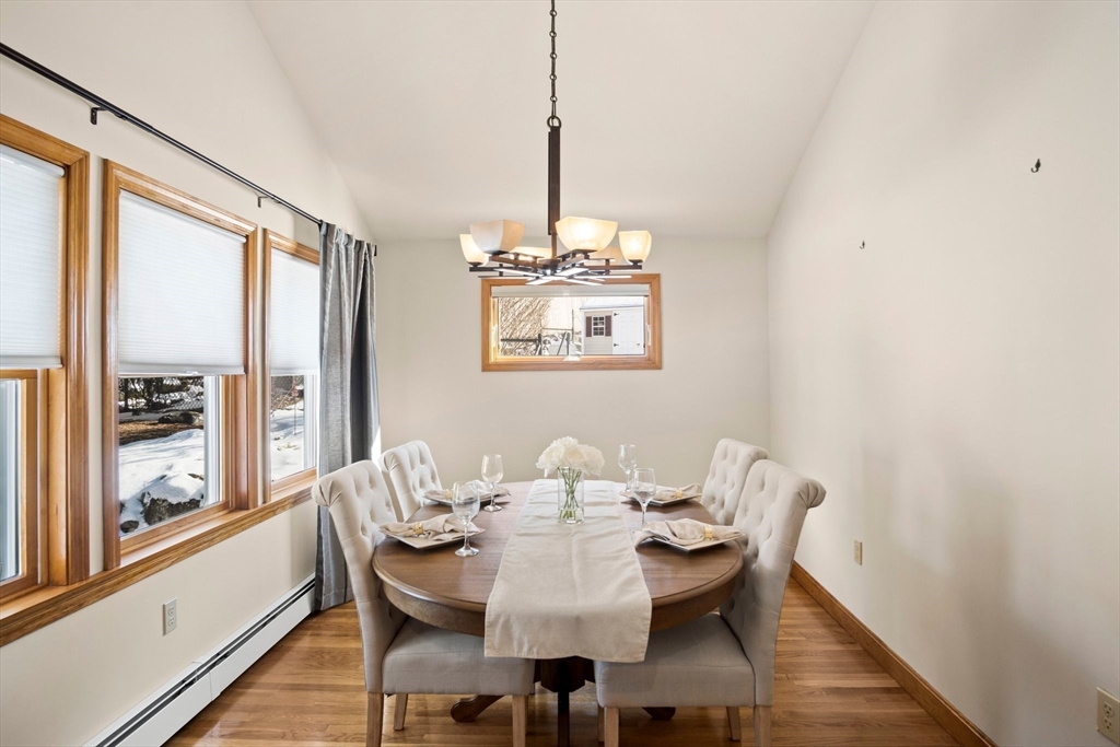 8 Grace Road Woburn, MA 01801 - Photo 11 of 37 a dining room with furniture a chandelier and wooden floor