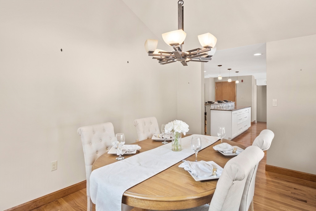 8 Grace Road Woburn, MA 01801 - Photo 12 of 37 a view of a dining room with furniture wooden floor and chandelier