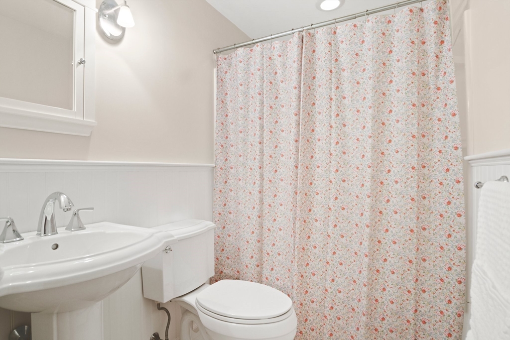 8 Grace Road Woburn, MA 01801 - Photo 16 of 37 a bathroom with a sink a toilet and shower curtain