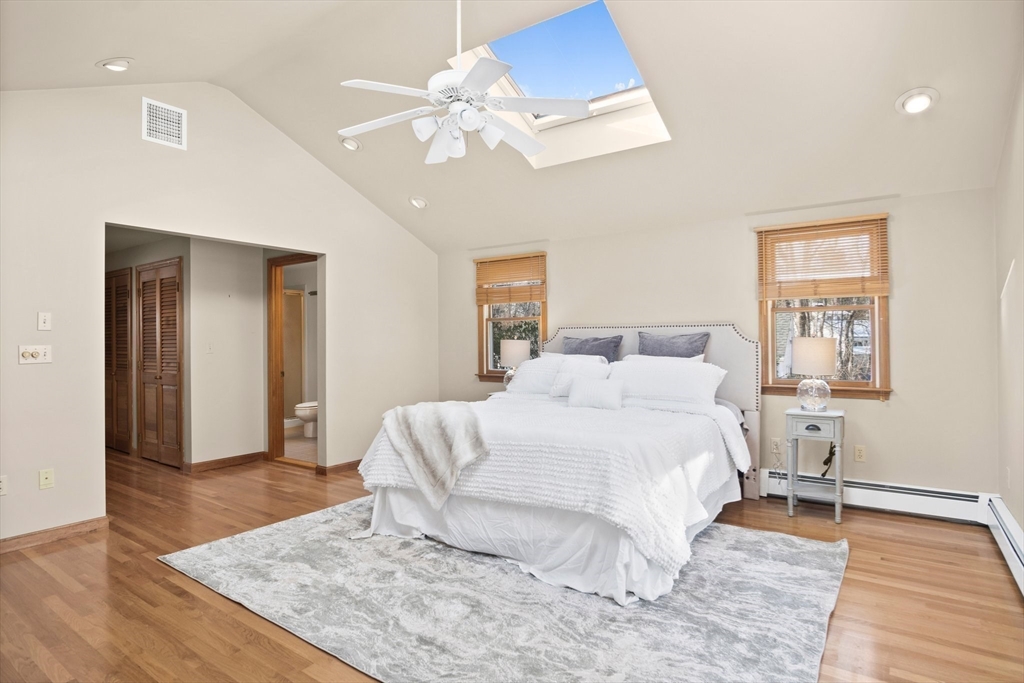 8 Grace Road Woburn, MA 01801 - Photo 17 of 37 a bedroom with a bed and a chandelier