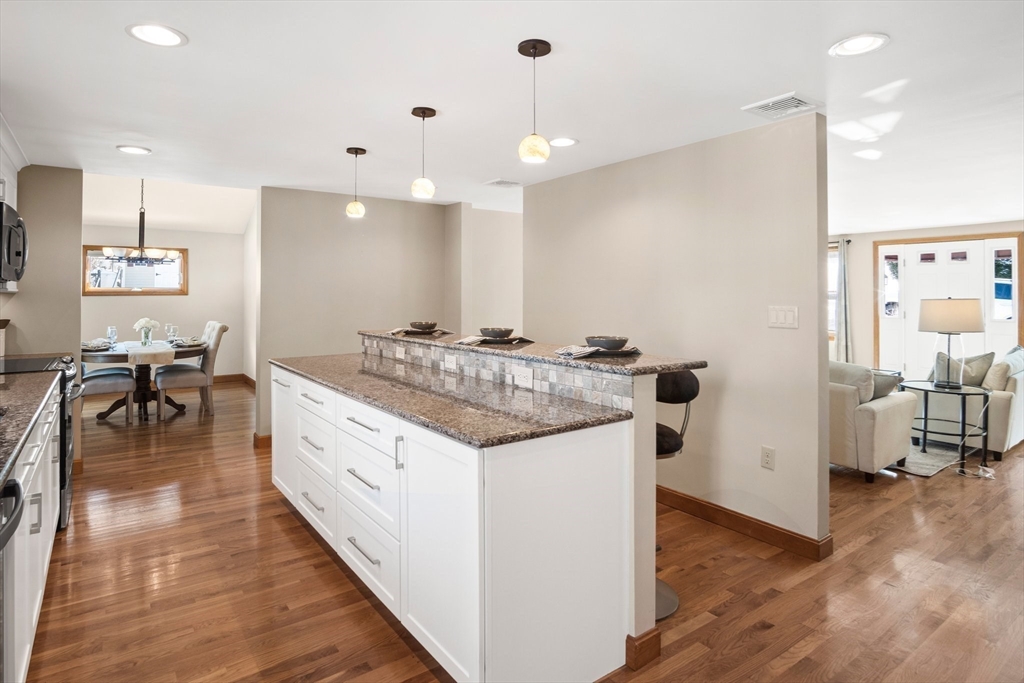 8 Grace Road Woburn, MA 01801 - Photo 7 of 37 a kitchen with stainless steel appliances granite countertop a sink and a refrigerator