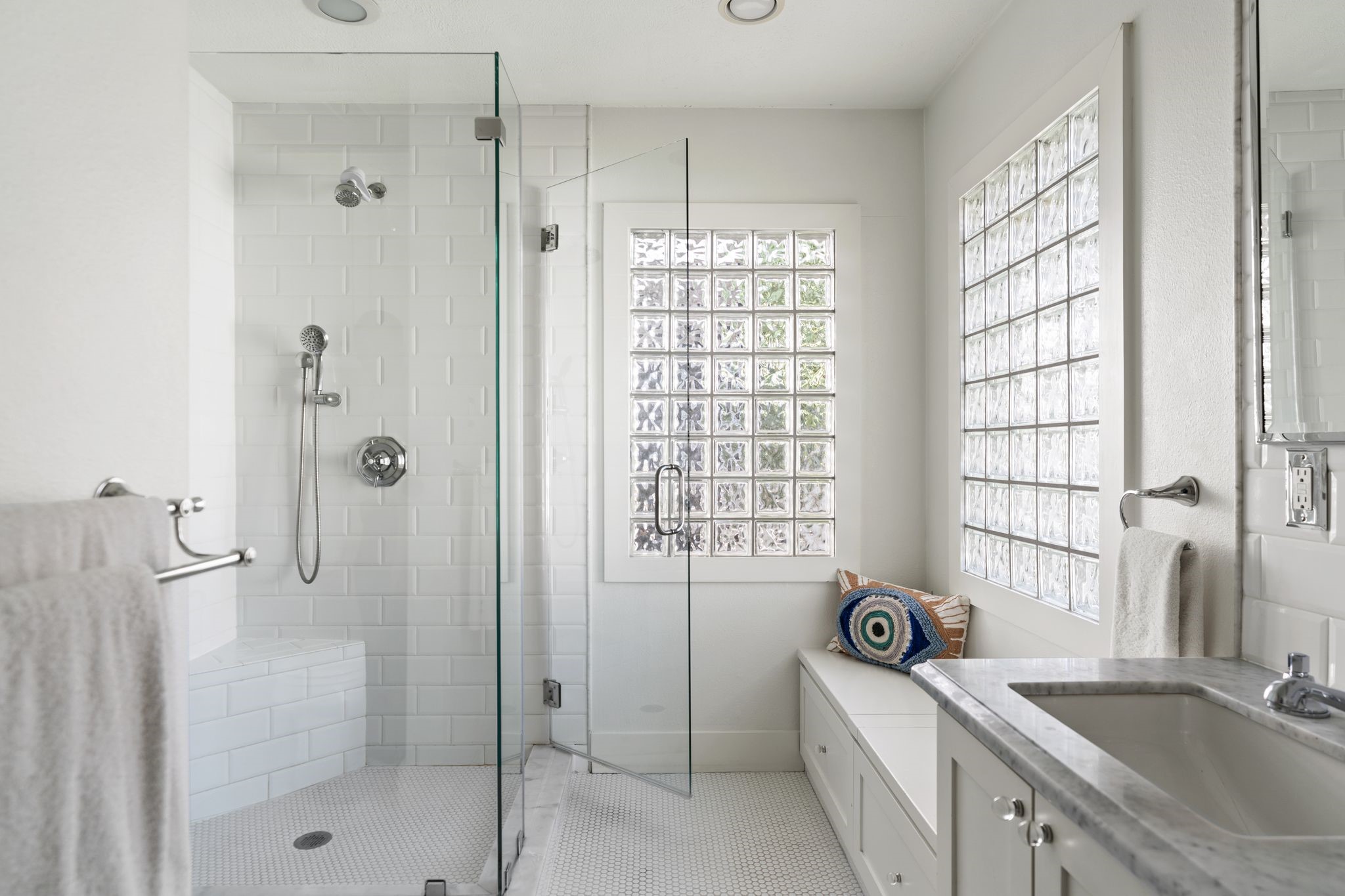 3914 Colquitt Street Houston, TX 77027 - Photo 14 of 36 The primary bathroom features a spacious walk-in shower with crisp white subway tile for a clean, timeless look. A built-in niche keeps shampoo and soap neatly tucked away while maintaining a streamlined design.