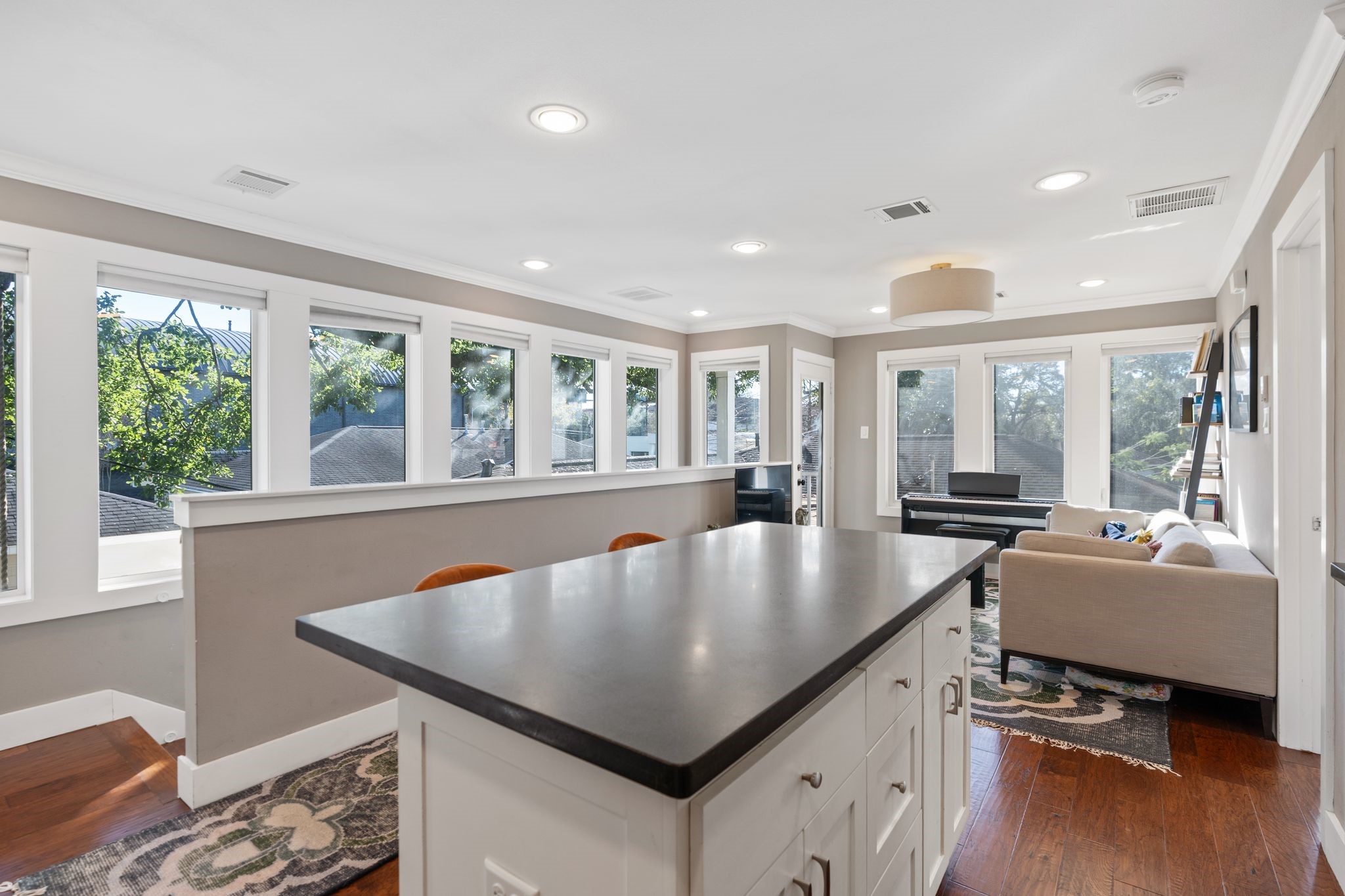 3914 Colquitt Street Houston, TX 77027 - Photo 22 of 36 This view is all about the wall of windows which brings in incredible natural light and frames the peaceful treetop views. It's a gorgeous backdrop that makes the space feel open and airy while giving you a serene private outlook over the surrounding greenery.