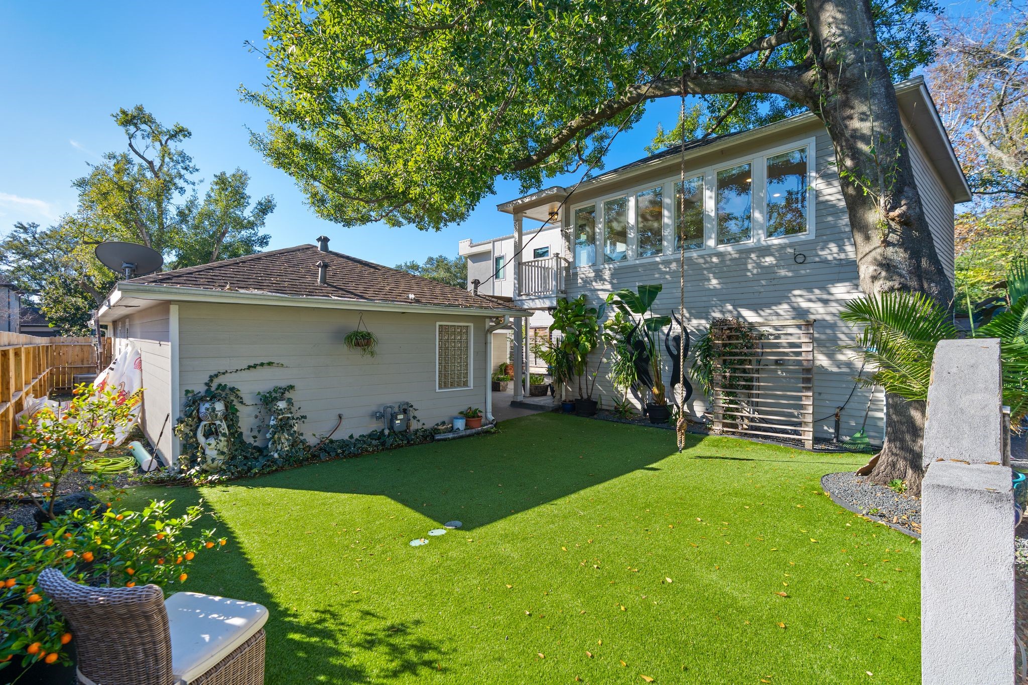 3914 Colquitt Street Houston, TX 77027 - Photo 27 of 36 This expansive private backyard offers an open turfed lawn with plenty of space to spread out and truly enjoy the outdoors. With the detached garage apartment positioned off to the side, the yard still feels large and usable, ideal for hosting friends, setting up lawn games, or letting pets/kids run around.