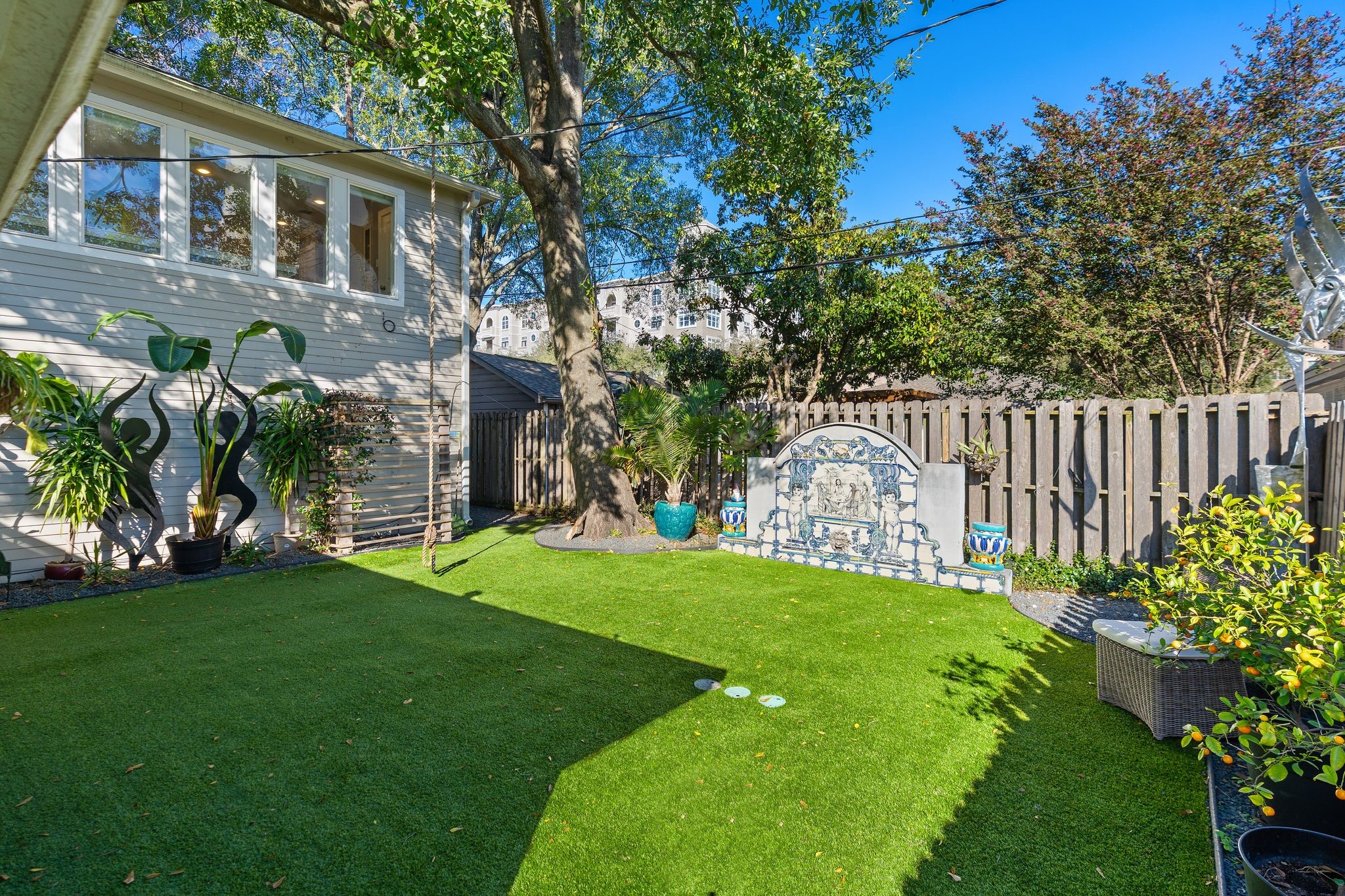 3914 Colquitt Street Houston, TX 77027 - Photo 28 of 36 A second view highlights just how oversized the backyard is, framed by mature trees and lush landscaping for a peaceful tucked away feel. The open green space gives you flexibility for entertaining, playing, or simply enjoying a quiet afternoon outside.