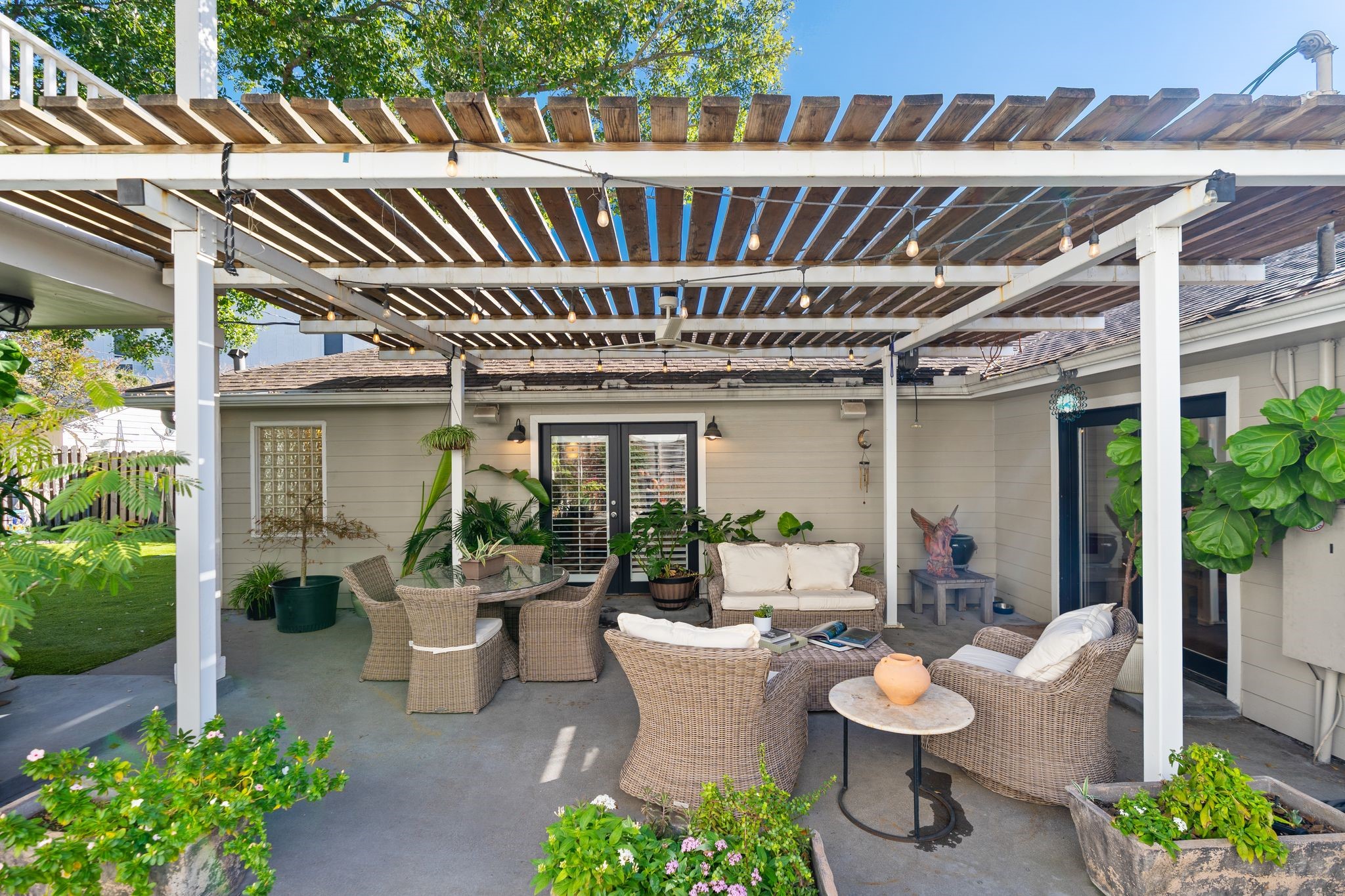 3914 Colquitt Street Houston, TX 77027 - Photo 29 of 36 The covered pergola patio creates a true outdoor living room with multiple seating areas and layout built for gatherings. Whether you're hosting a dinner, watching the game outside, or having friends over for cocktails, this space is set up to make entertaining easy and fun.