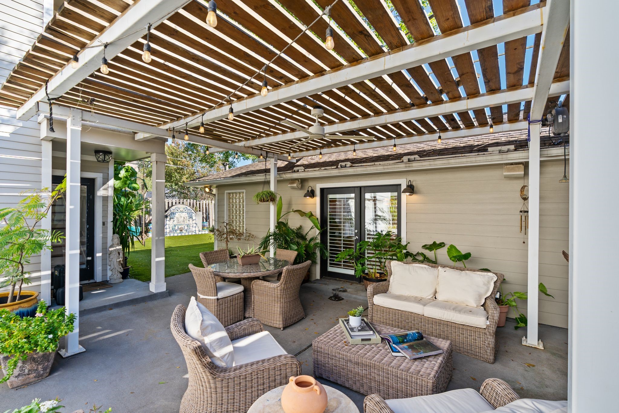 3914 Colquitt Street Houston, TX 77027 - Photo 30 of 36 This angle shows that inviting lounge setup under the pergola complete with lights that make evenings outside feel special. It's an effortless space for weekend get-togethers, casual hangouts, or winding down at the end of the day.
