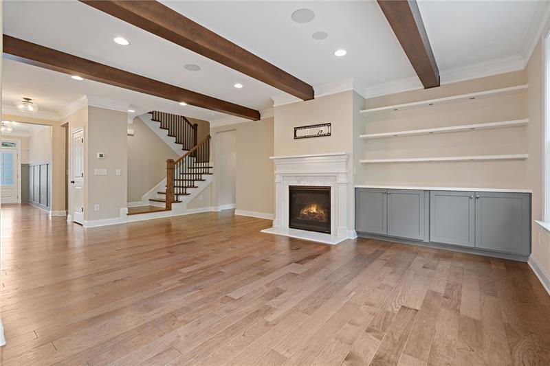 4105 Bellehurst Lane Cumming, GA 30040 - Photo 12 of 48 a view of an empty room with wooden floor and a fireplace