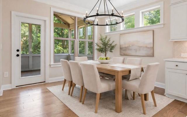 4105 Bellehurst Lane Cumming, GA 30040 - Photo 14 of 48 a dining room with furniture a chandelier and wooden floor