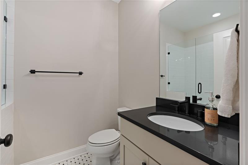 4105 Bellehurst Lane Cumming, GA 30040 - Photo 19 of 48 a bathroom with a granite countertop sink and a mirror