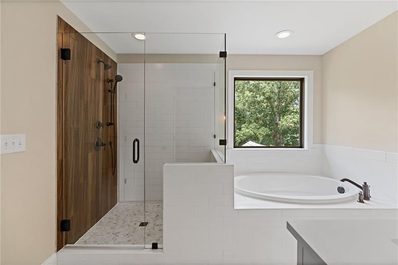 4105 Bellehurst Lane Cumming, GA 30040 - Photo 25 of 48 a bathroom with a bathtub and a shower