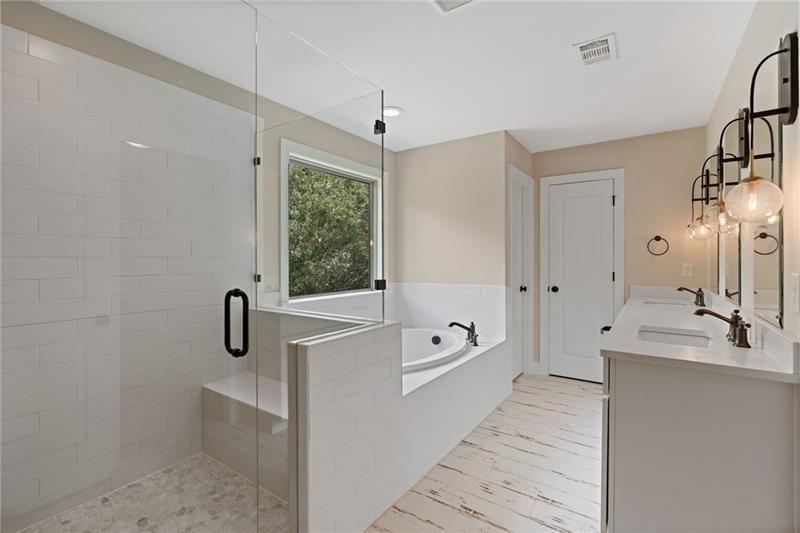 4105 Bellehurst Lane Cumming, GA 30040 - Photo 26 of 48 a bathroom with a tub a sink and mirror