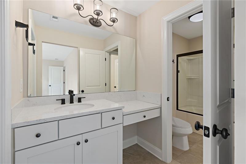 4105 Bellehurst Lane Cumming, GA 30040 - Photo 30 of 48 a bathroom with a sink and mirror