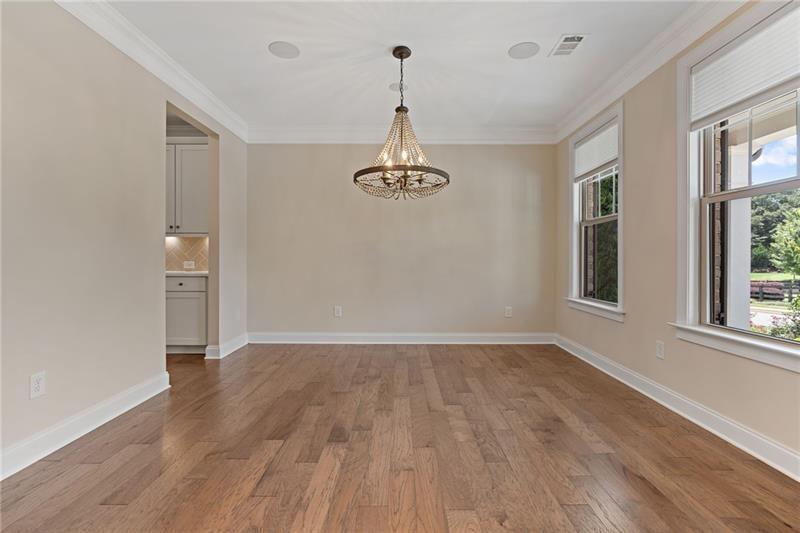 4105 Bellehurst Lane Cumming, GA 30040 - Photo 5 of 48 a view of a room with wooden floor chandelier and windows