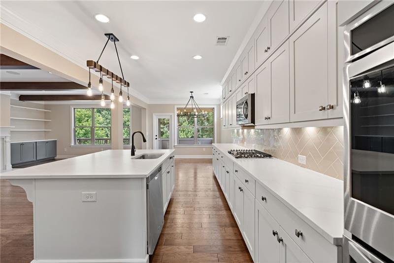 4105 Bellehurst Lane Cumming, GA 30040 - Photo 8 of 48 a large white kitchen with sink and window
