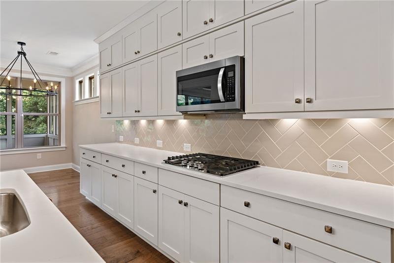 4105 Bellehurst Lane Cumming, GA 30040 - Photo 9 of 48 a kitchen with granite countertop white cabinets stainless steel appliances and a sink