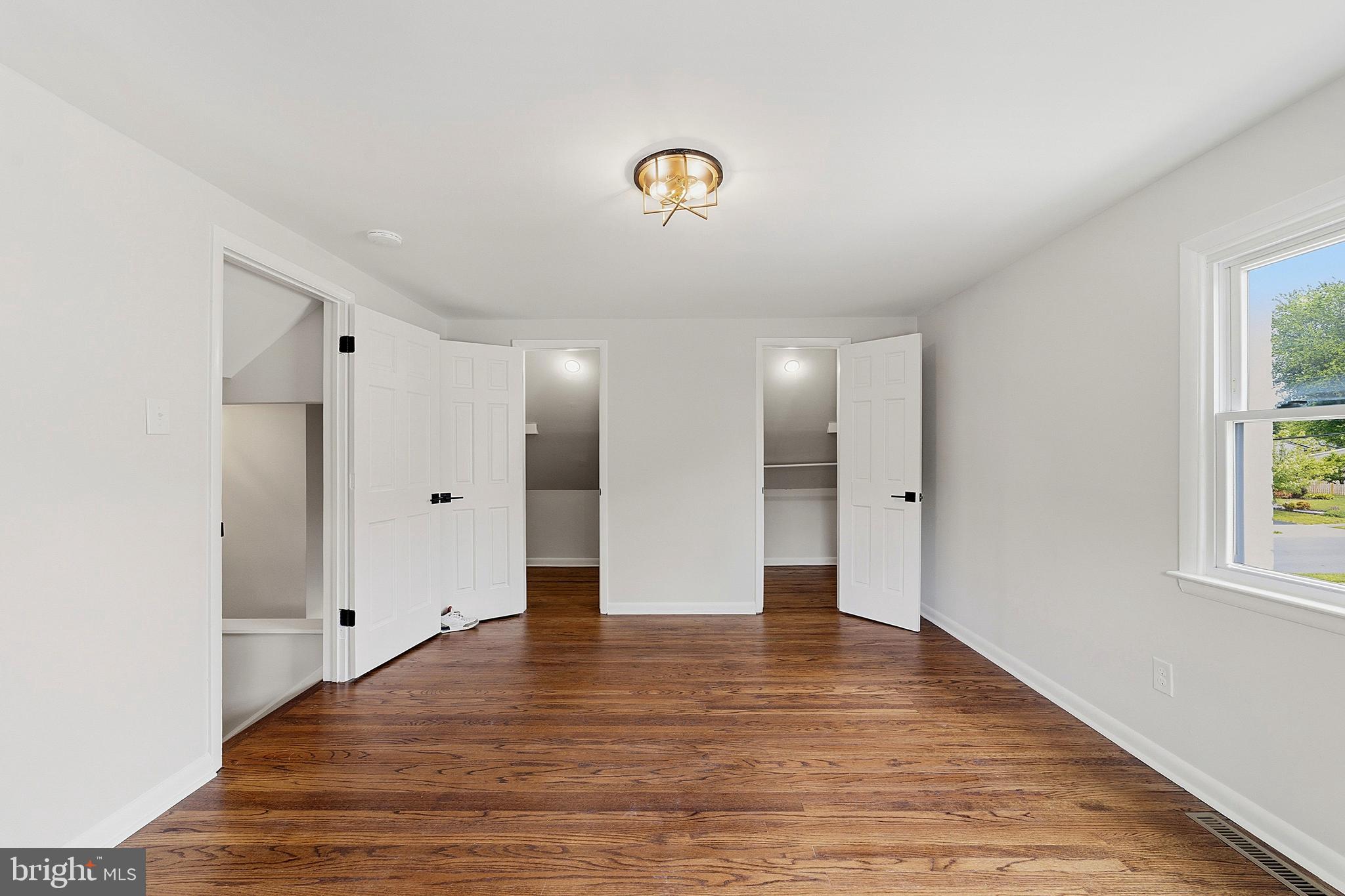 117 Harvest Road Cherry Hill, NJ 08002 - Photo 31 of 35 a view of an empty room with window and wooden floor