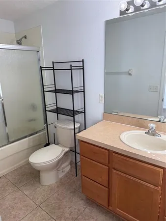 a bathroom with a toilet a sink and shower