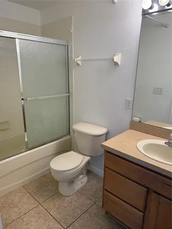 an empty room with windows and cabinet