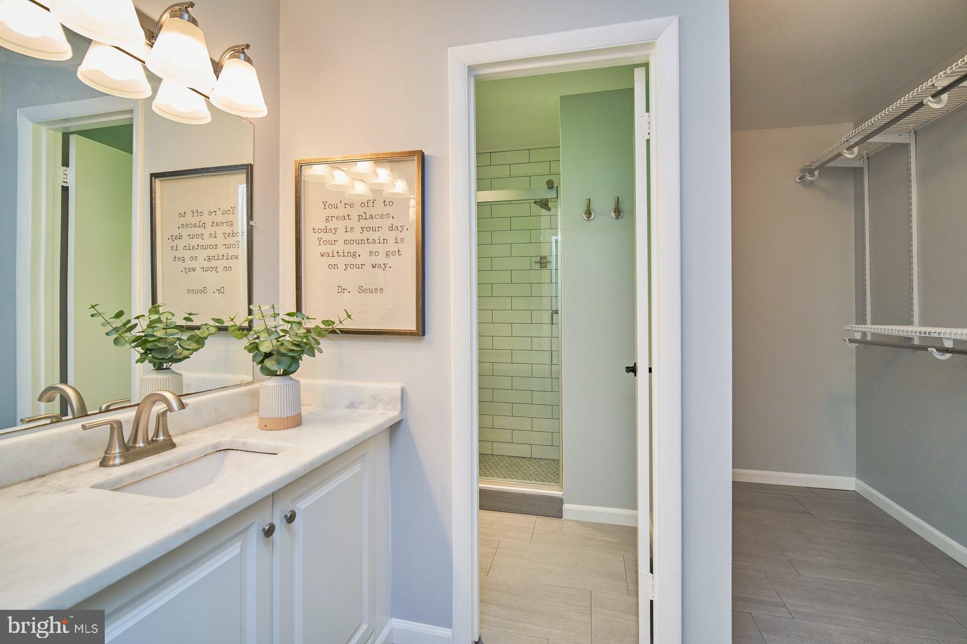 1944 Winterport Cluster Reston, VA 20191 - Photo 14 of 35 a bathroom with a granite countertop sink a mirror and a shower
