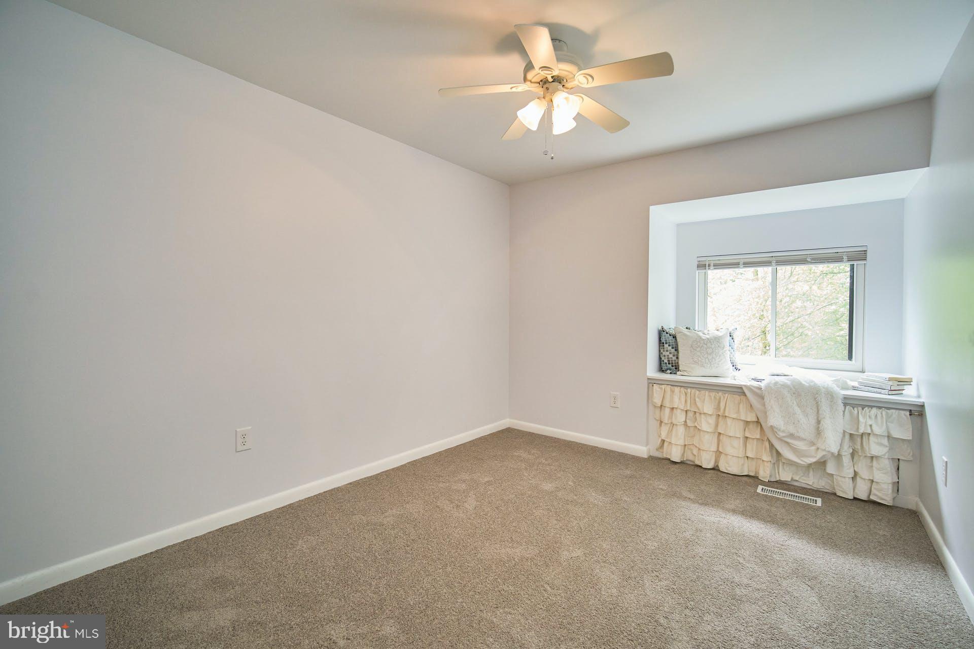 1944 Winterport Cluster Reston, VA 20191 - Photo 16 of 35 an empty room with chandelier fan and windows