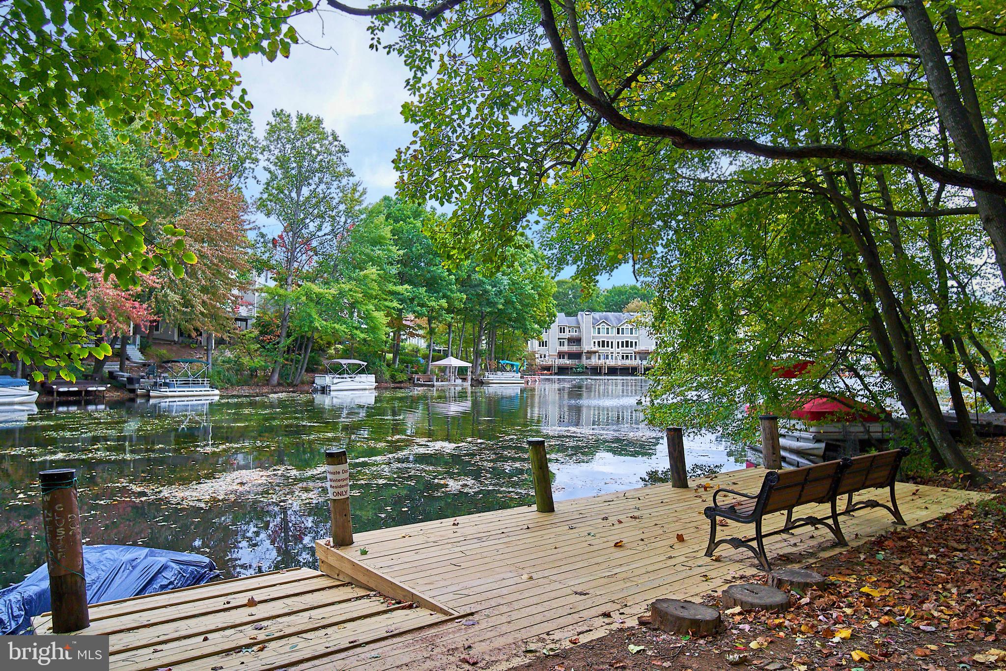 1944 Winterport Cluster Reston, VA 20191 - Photo 24 of 35 a wooden bench sitting next to a lake