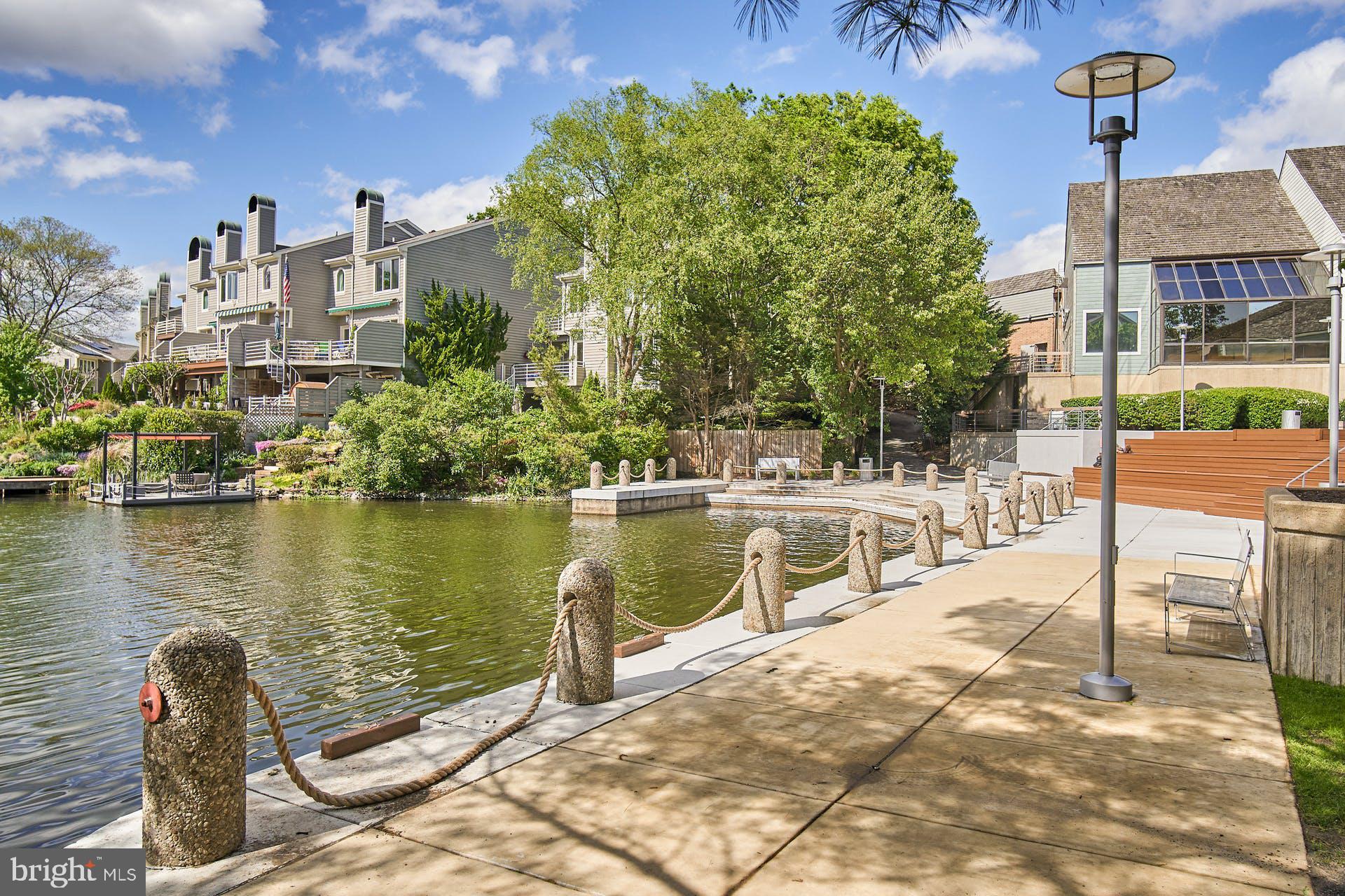 1944 Winterport Cluster Reston, VA 20191 - Photo 27 of 35 a view of a lake with a bench and trees