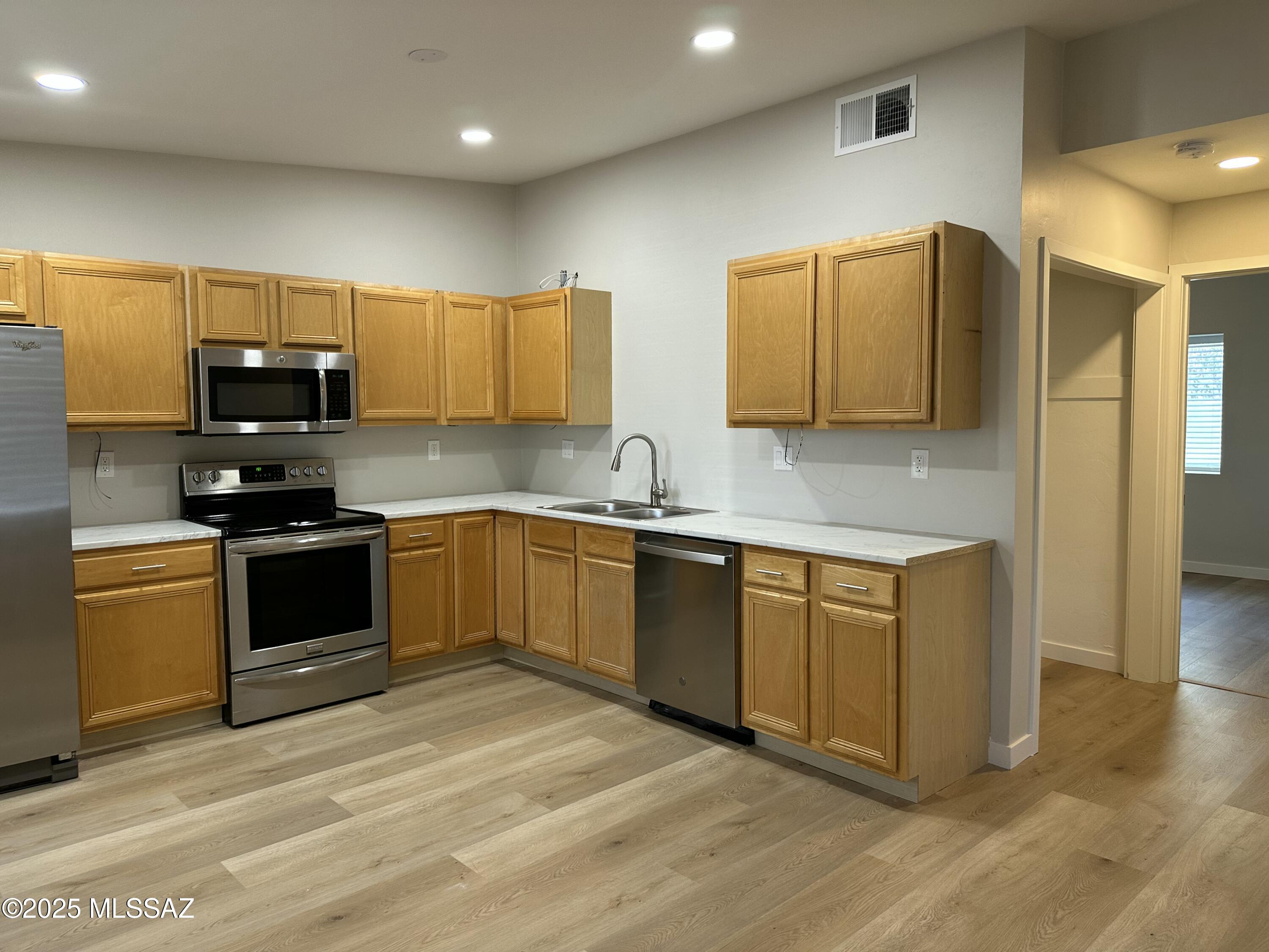 645 East Mabel Street Tucson, AZ 85705 - Photo 5 of 22 a kitchen with stainless steel appliances granite countertop a stove a sink and a refrigerator