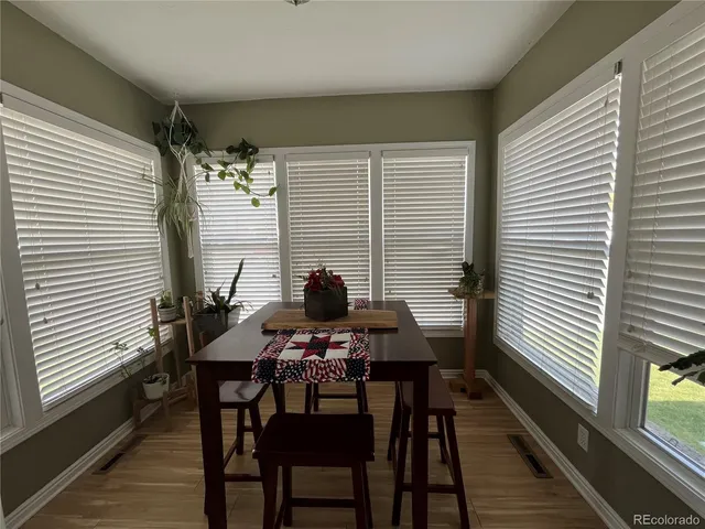 a view of a dining room with furniture and wooden floor