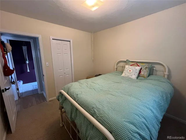 a bedroom with a bed and a mirror