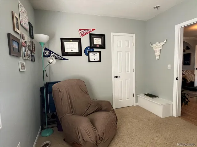 a living room with furniture and a painting