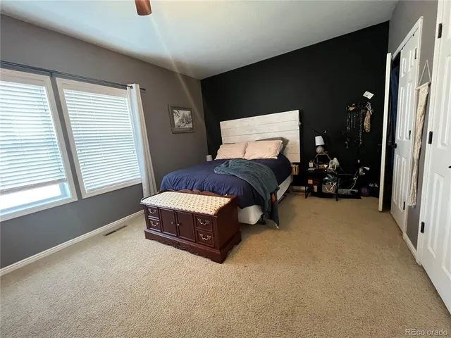 a living room with a bed furniture and a window