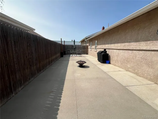a view of a two dinning table and chairs in the balcony